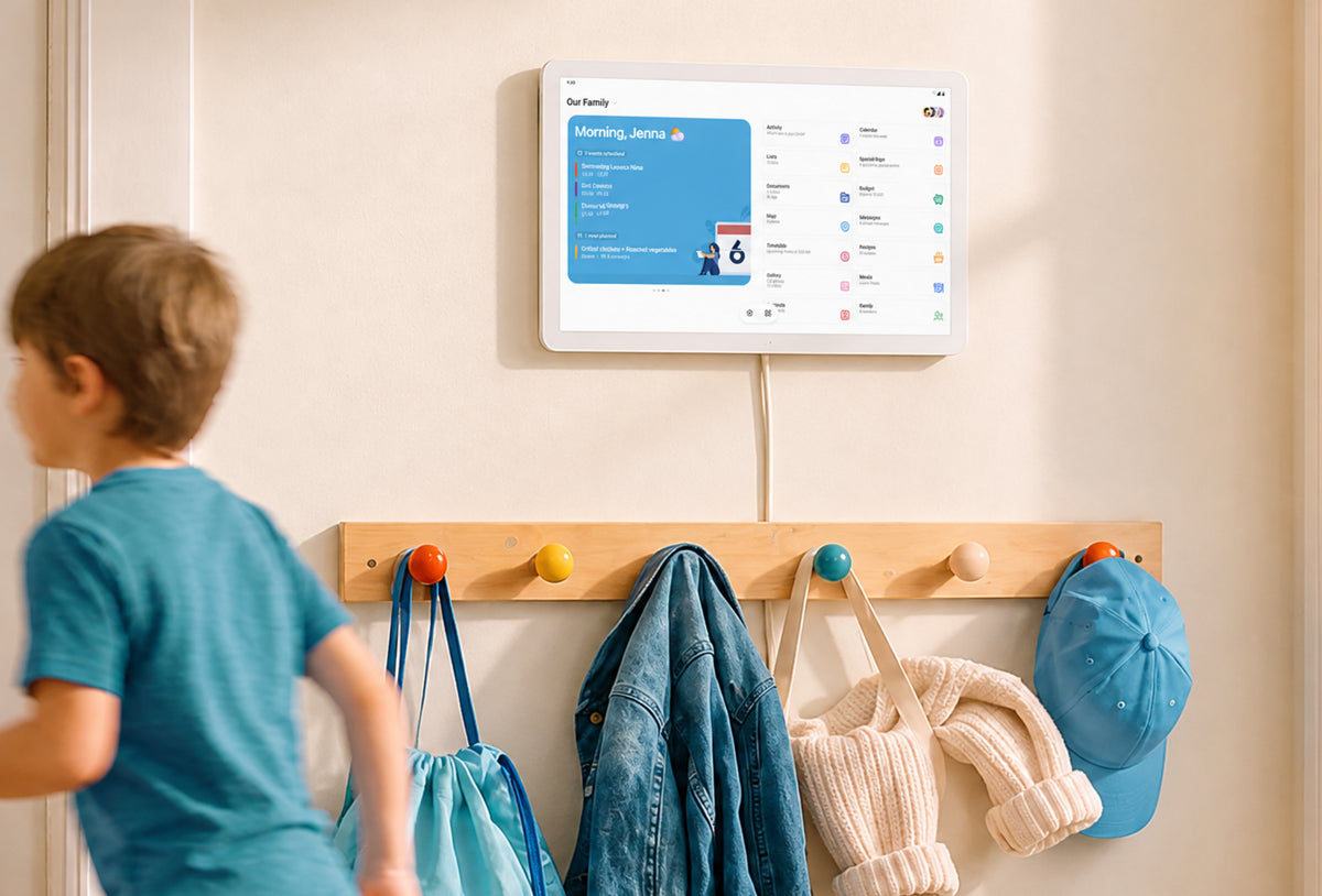 Home Hub wall-mounted above a coat rack showing the family calendar as a child runs past